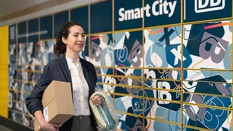 Woman carrying shipment with lockers in the background
